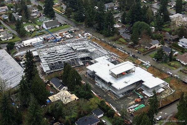 aerial view with a building that has metal roofing on top of steel structure and another building that is just steel structure